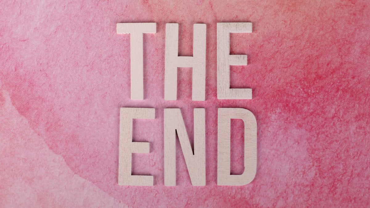 Elegant 'The End' text on a textured pink background, perfect for closure or transition concepts.